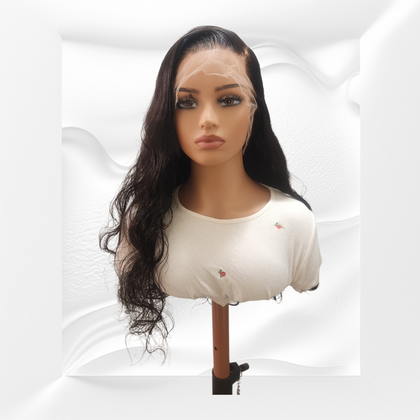 Mannequin head with long black body wave wig on a white background