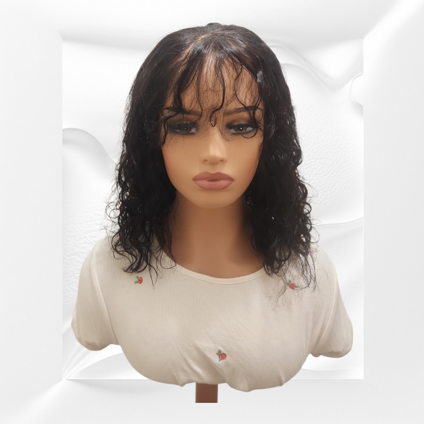 Mannequin head with a black wig on a white background