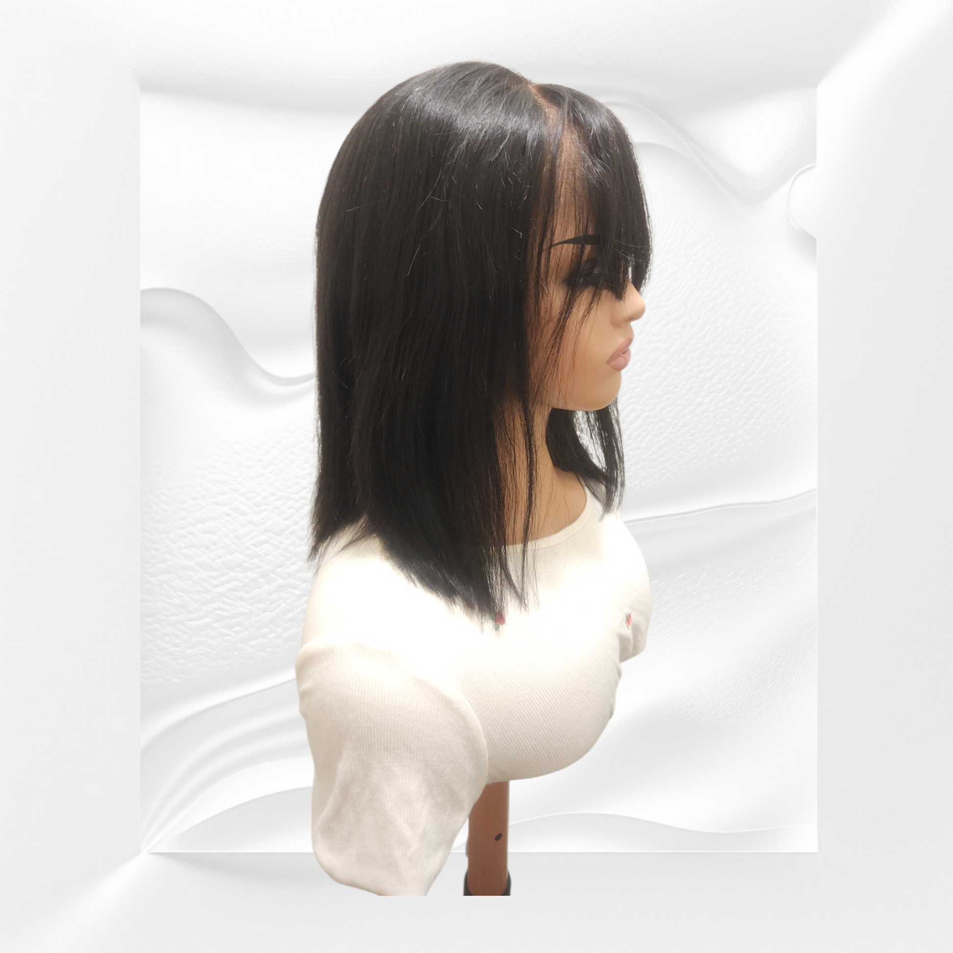 Mannequin head with a black straight wig on a white background