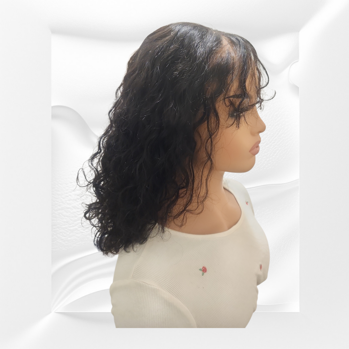 Mannequin head with a black wig on a white background