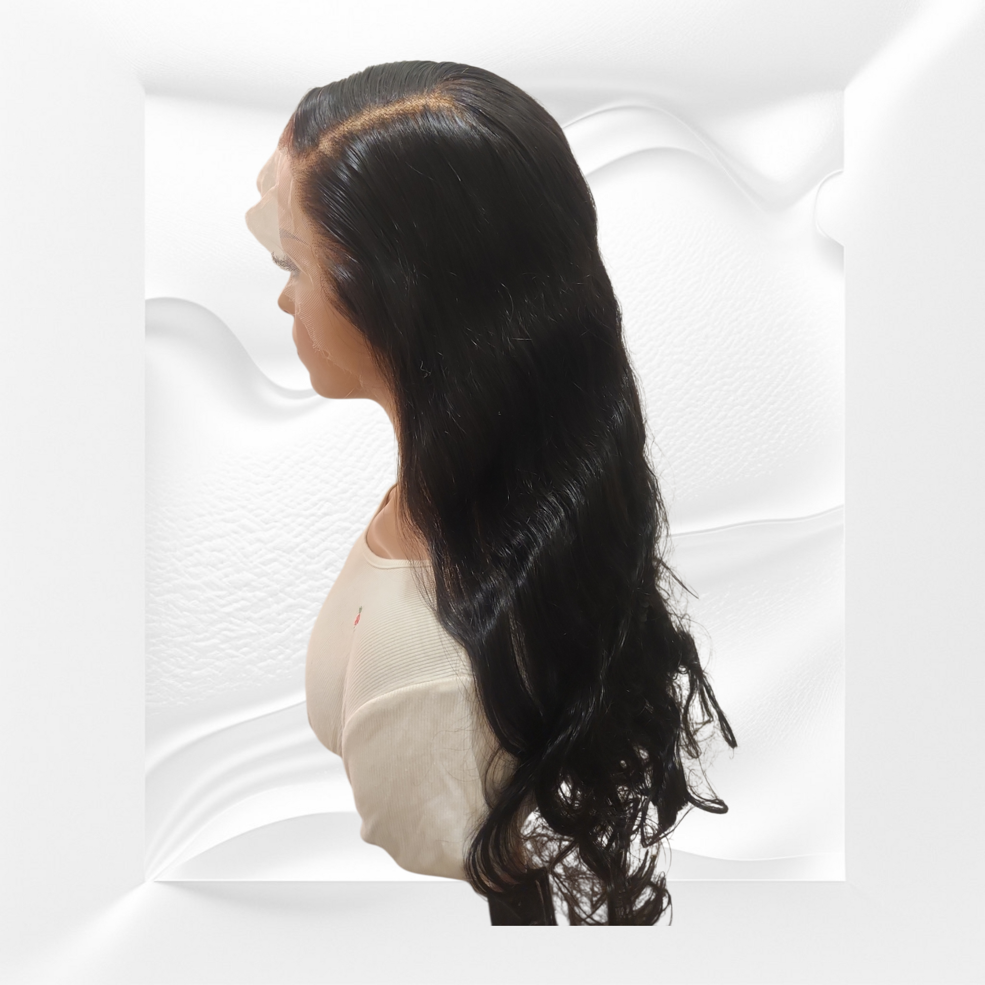 Mannequin head with long black hair styled in loose waves on a white background