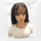 Mannequin head with a black wig on a white background