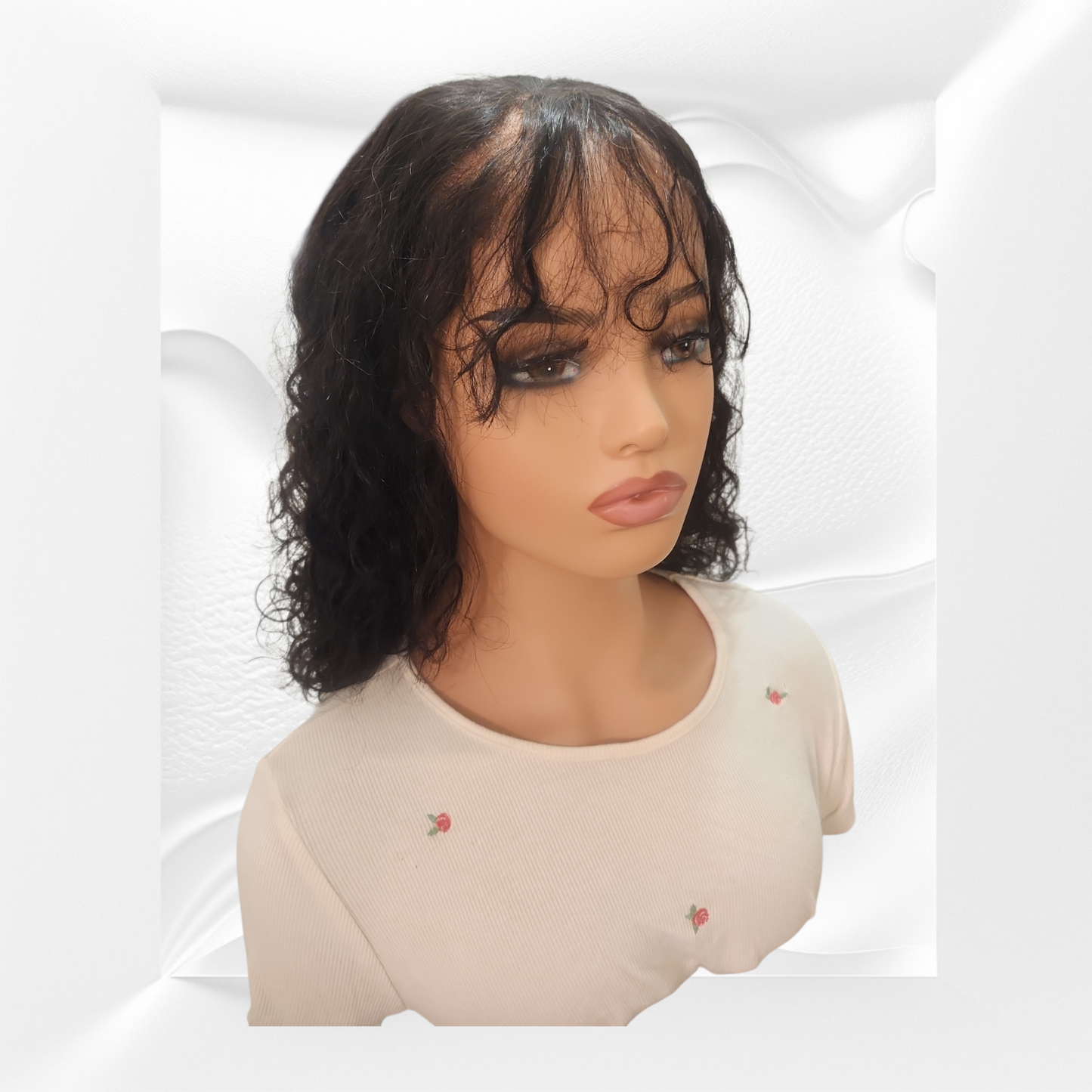 Mannequin head with a black wig on a white background