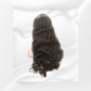 Black wavy hair wig on a mannequin head against a white background