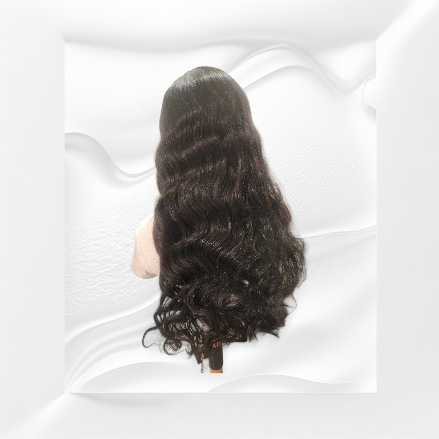 Black wavy hair wig on a mannequin head against a white background